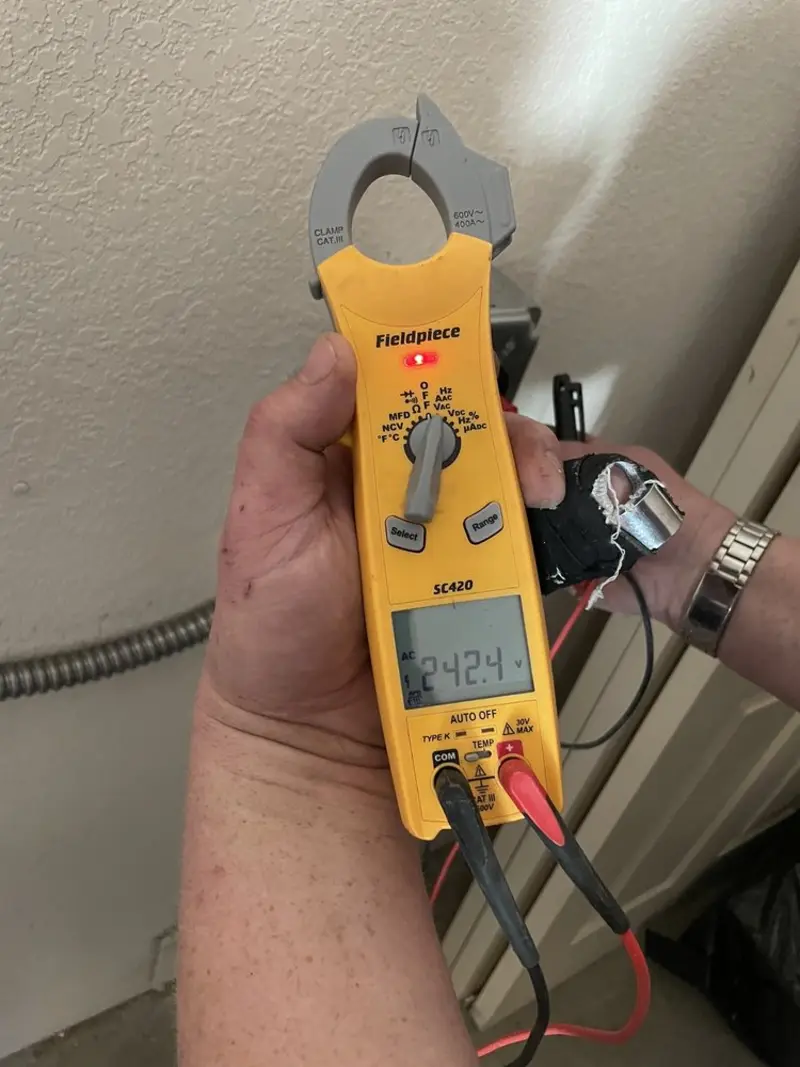 Voltage testing with clamp meter during Recessed Lighting Installation in Island Lake